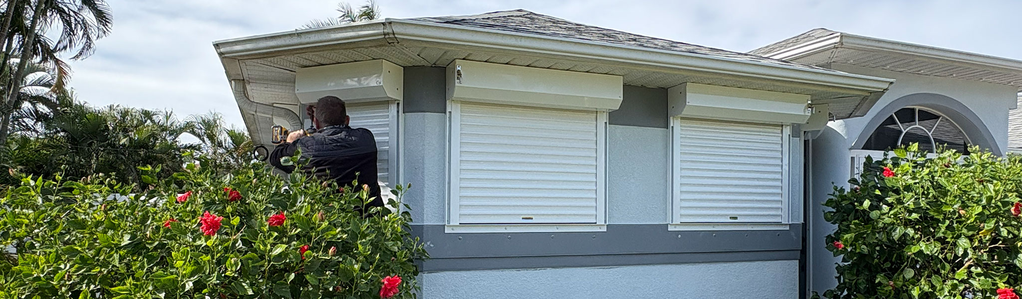 Man Installing Roll Down Shutters